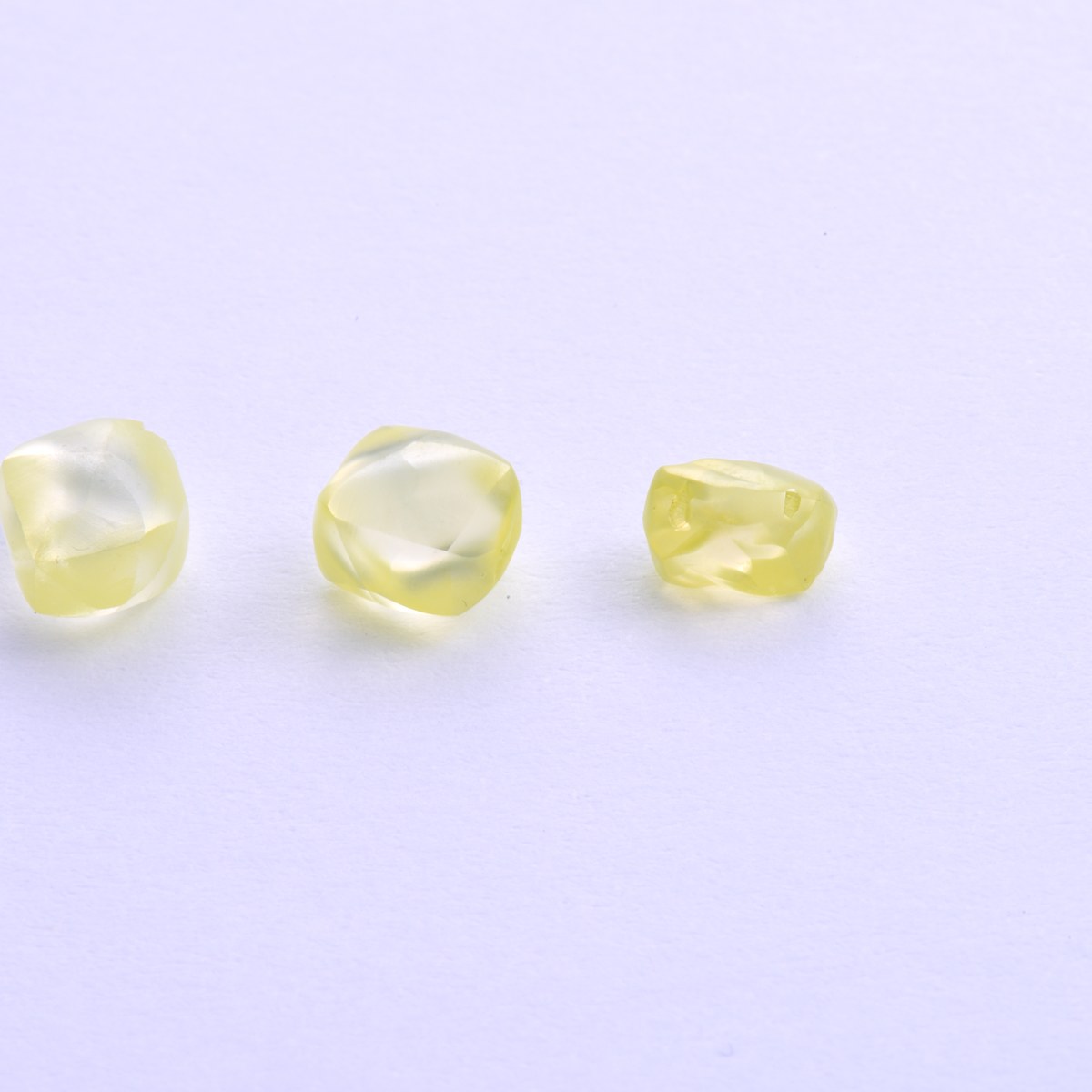 Three natural fancy-yellow diamond crystals